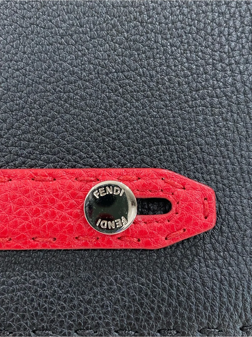 Fendi Selleria flat clutch bag with red stitching and red leather handle
